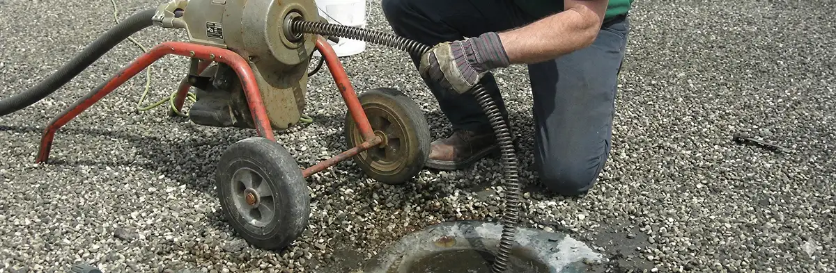 sewer rodding technician actively removing blockages from a sewer line in Bradenton, FL